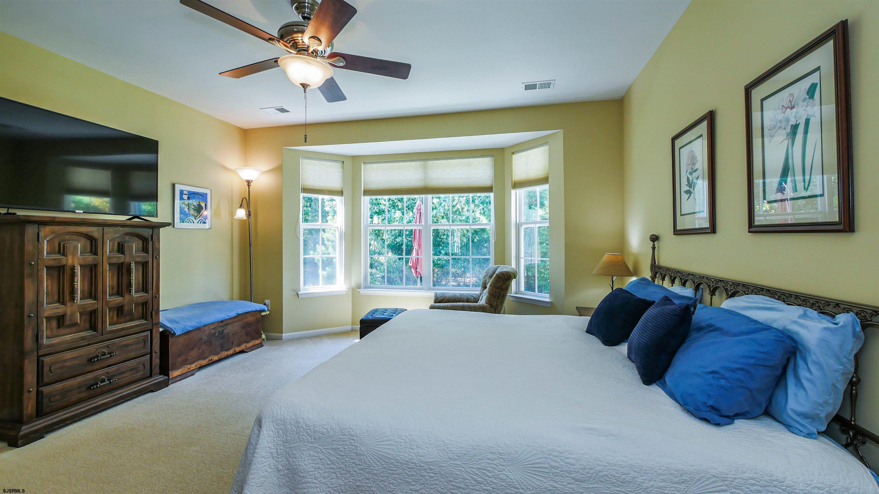 33 Brampton Street Smithville, NJ 08205 - Photo 26 of 37 a spacious bedroom with a bed and a flat screen tv