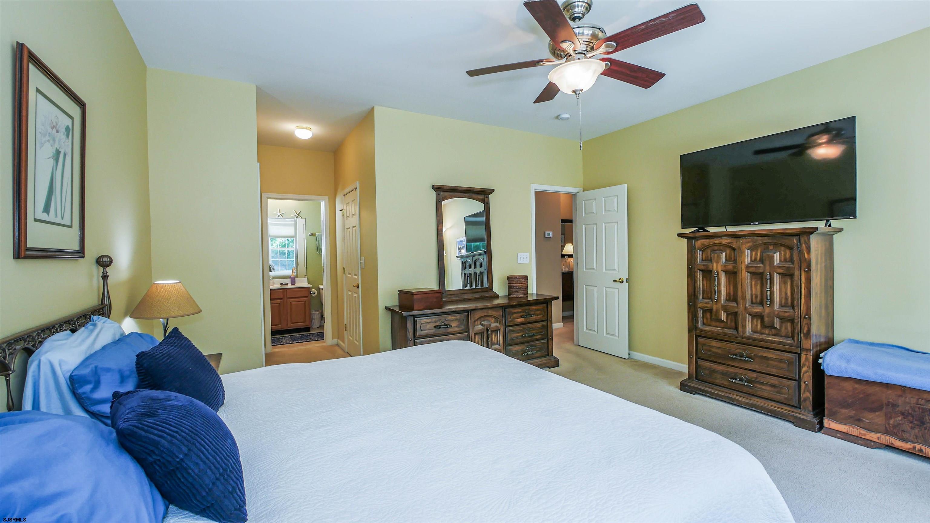 33 Brampton Street Smithville, NJ 08205 - Photo 27 of 37 a bedroom with a bed and a flat screen tv