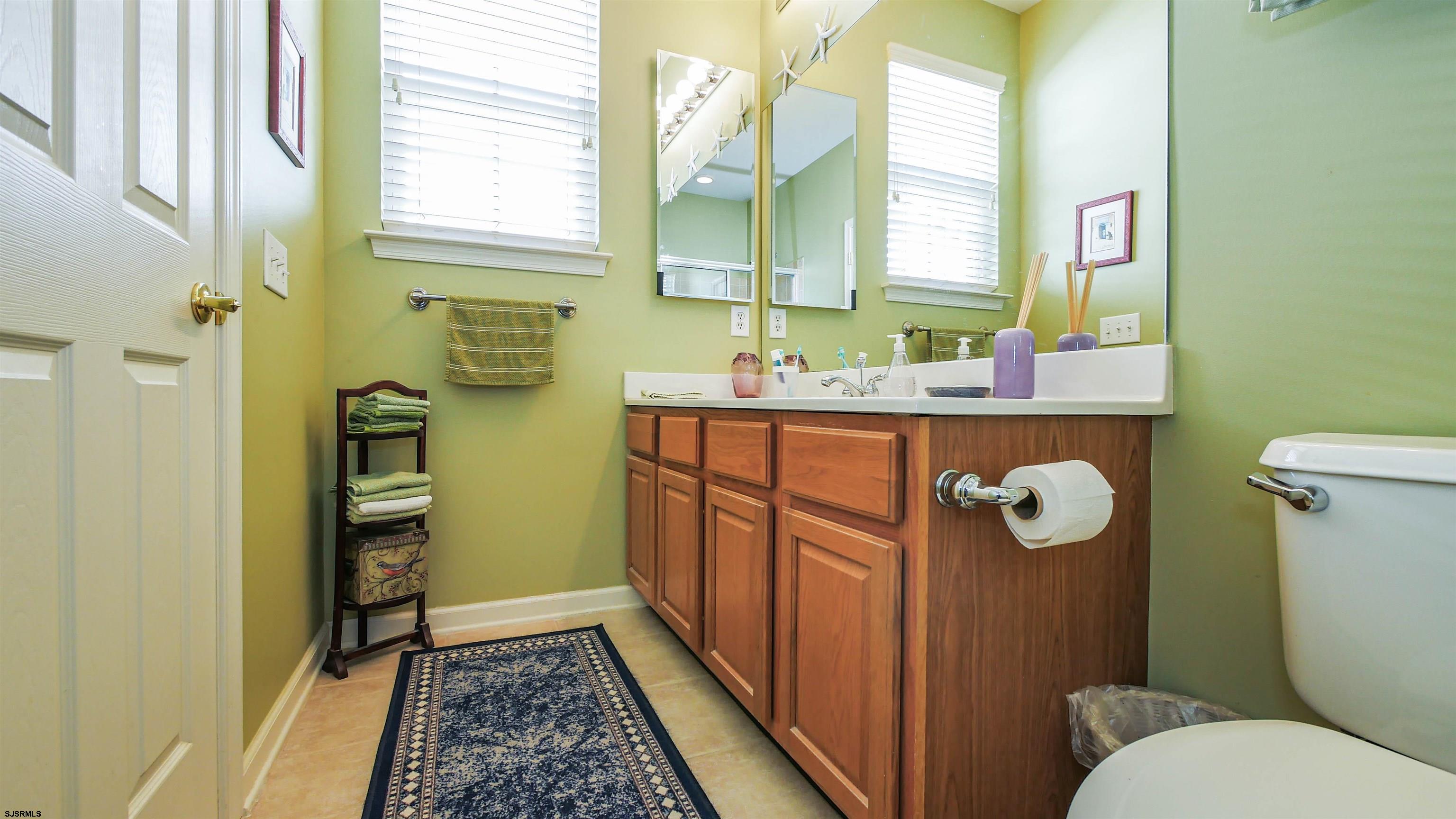 33 Brampton Street Smithville, NJ 08205 - Photo 30 of 37 a bathroom with a sink a toilet and a mirror