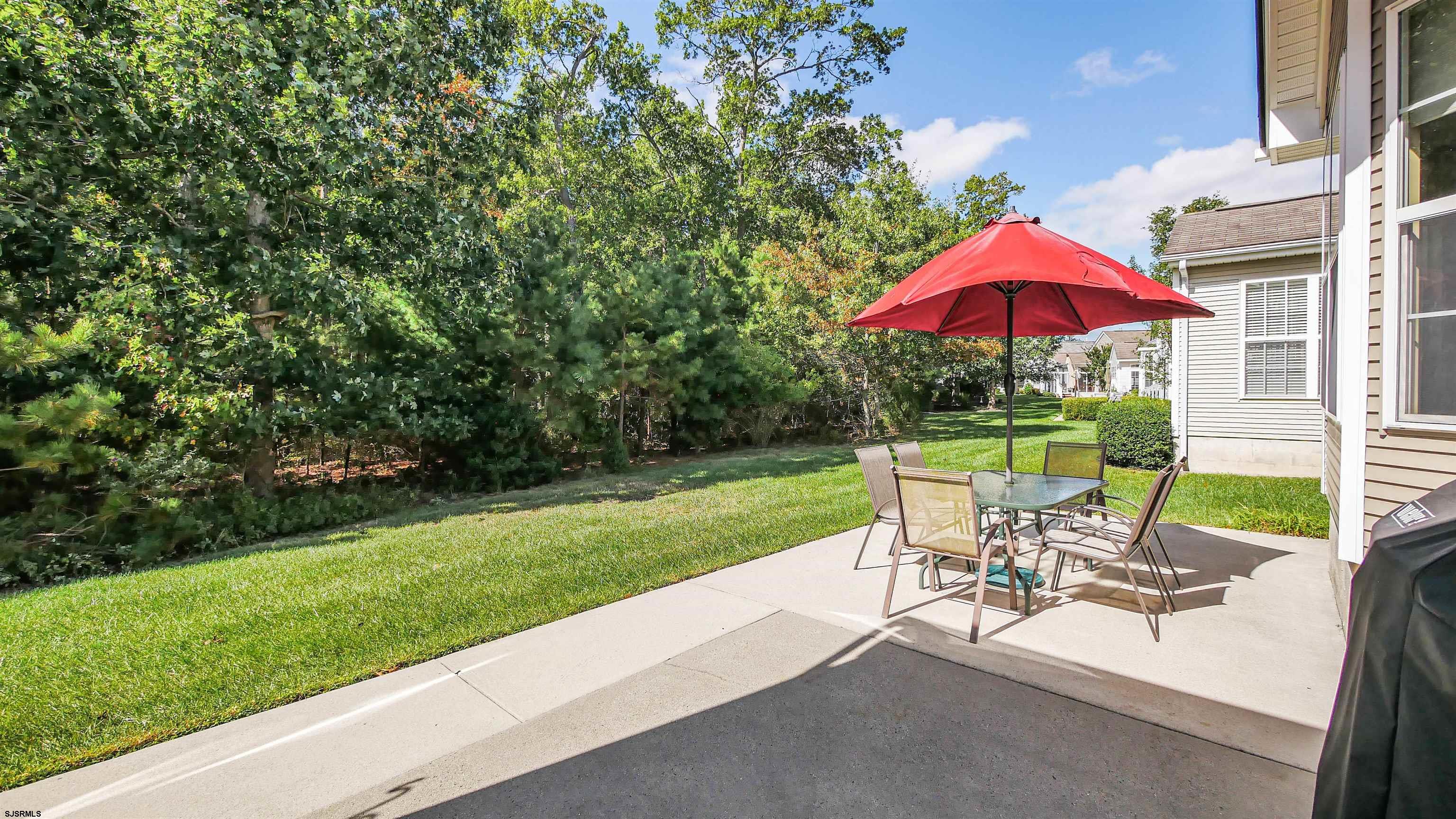 33 Brampton Street Smithville, NJ 08205 - Photo 33 of 37 a view of backyard with seating space and garden