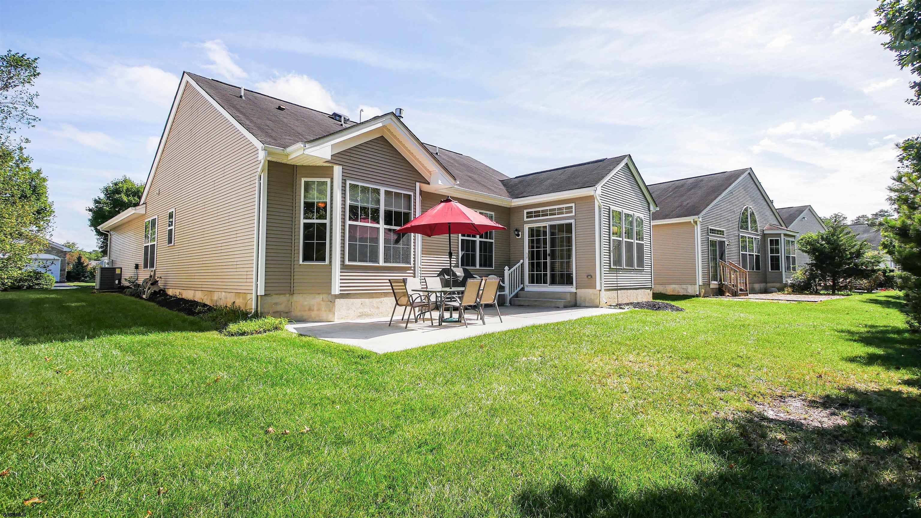33 Brampton Street Smithville, NJ 08205 - Photo 35 of 37 a view of a house with a yard patio and fire pit