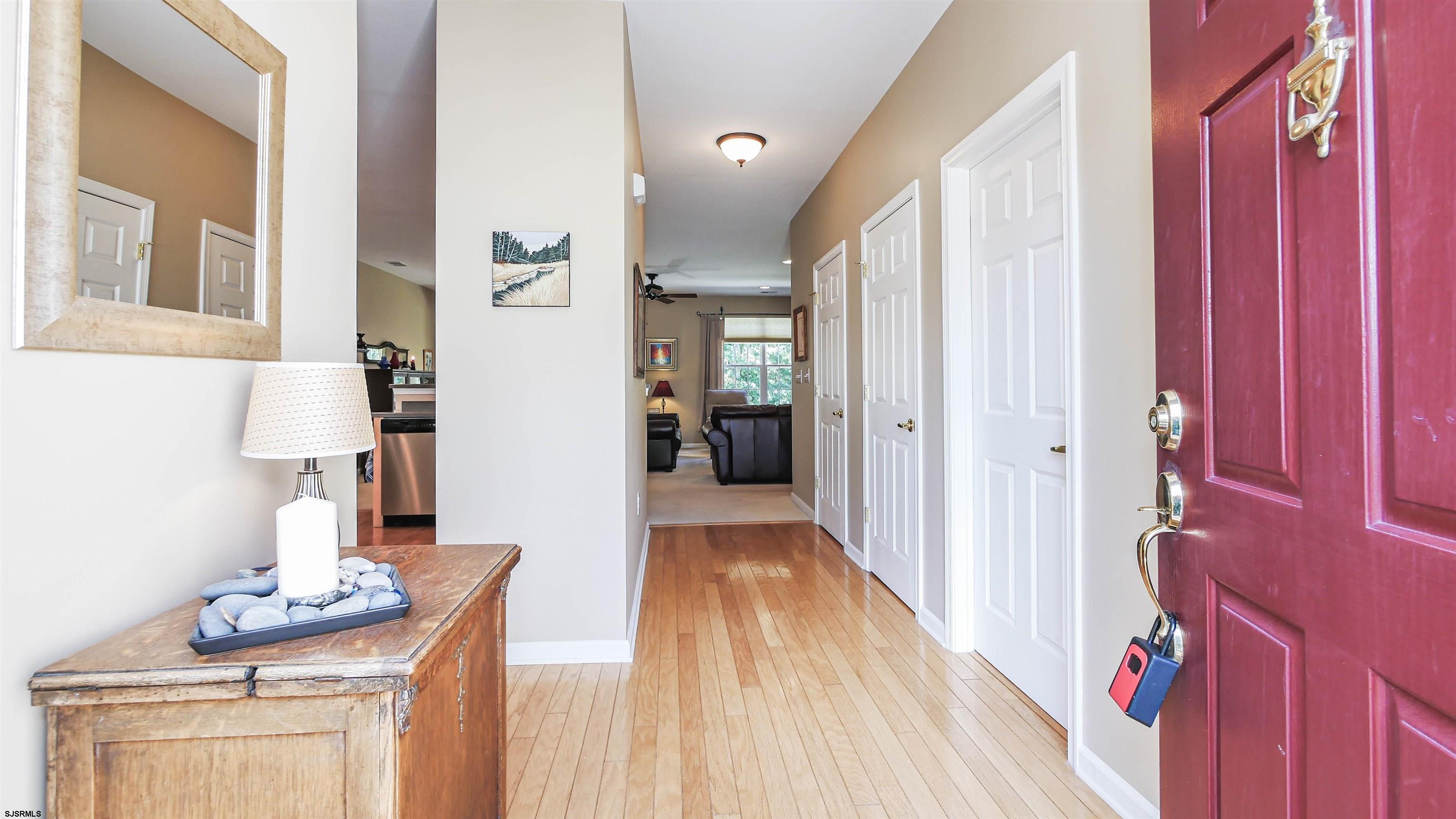 33 Brampton Street Smithville, NJ 08205 - Photo 5 of 37 a view of a hallway with wooden floor and windows