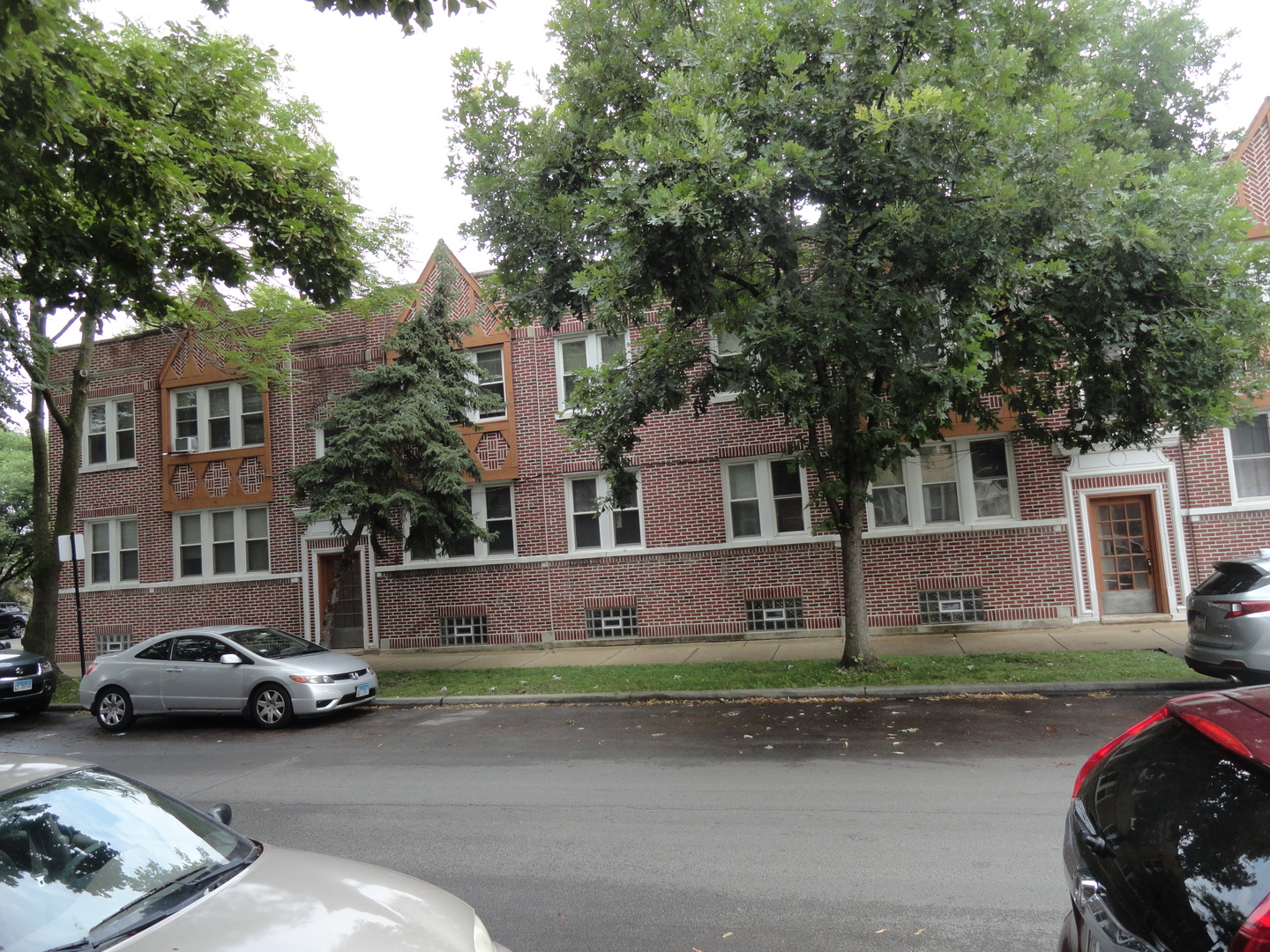5514 West George Street Chicago, IL 60641 - Photo 1 of 9 a city street lined with buildings and cars