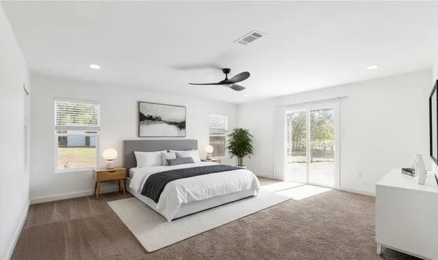 a bedroom with a large bed and a window