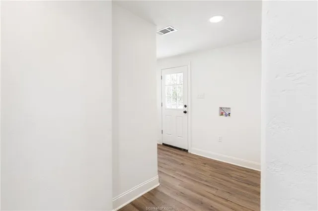 a view of a room with wooden floor