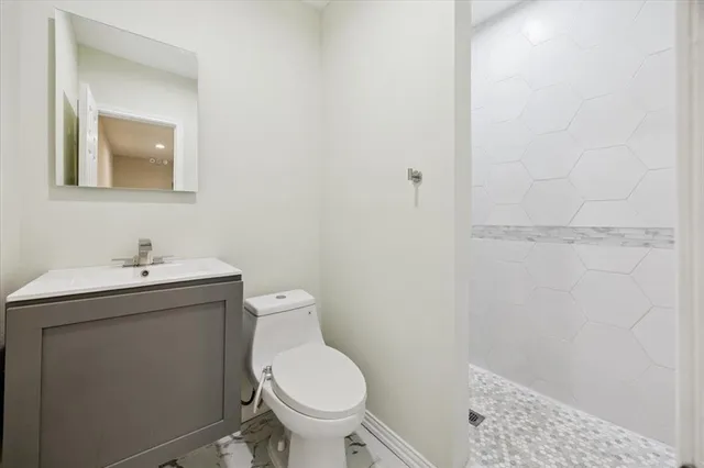 a bathroom with a sink toilet and vanity