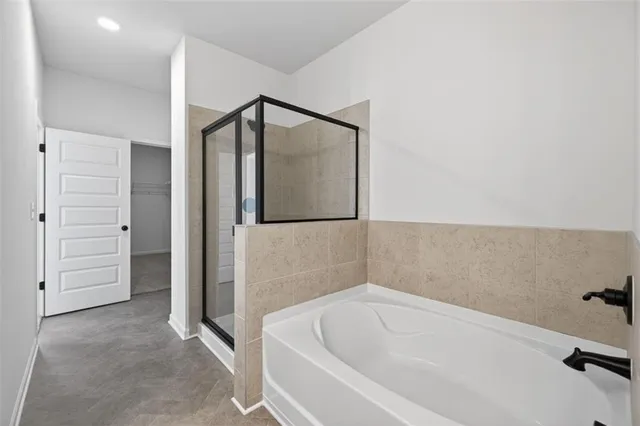 a bathroom with a bathtub and a shower