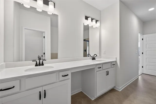a bathroom with a sink double vanity and a mirror