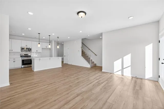 a view of a kitchen with wooden floor and electronic appliances