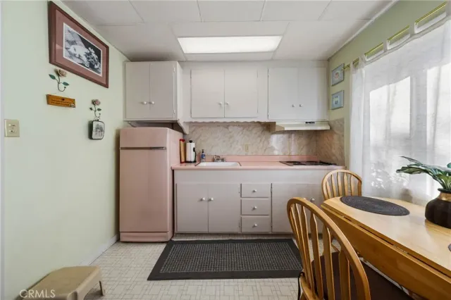 a bedroom with a bed and a dresser next to a window