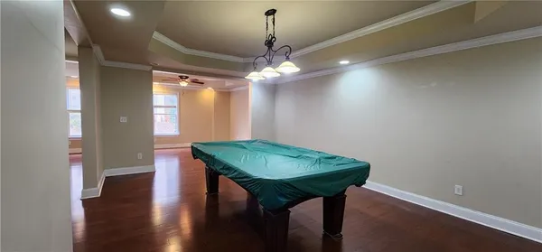 a view of a room with furniture and wooden floor