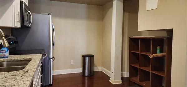 a kitchen with granite countertop a stove and a sink