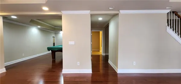 a view of hallway with stairs and wooden floor