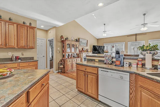 a kitchen with stainless steel appliances granite countertop a sink and cabinets