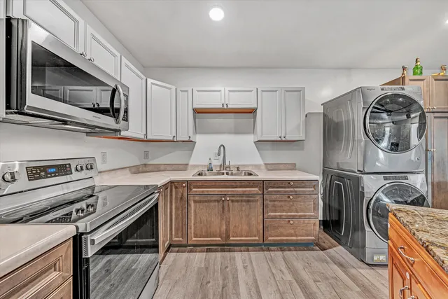 a kitchen with a counter space cabinets and wooden floor