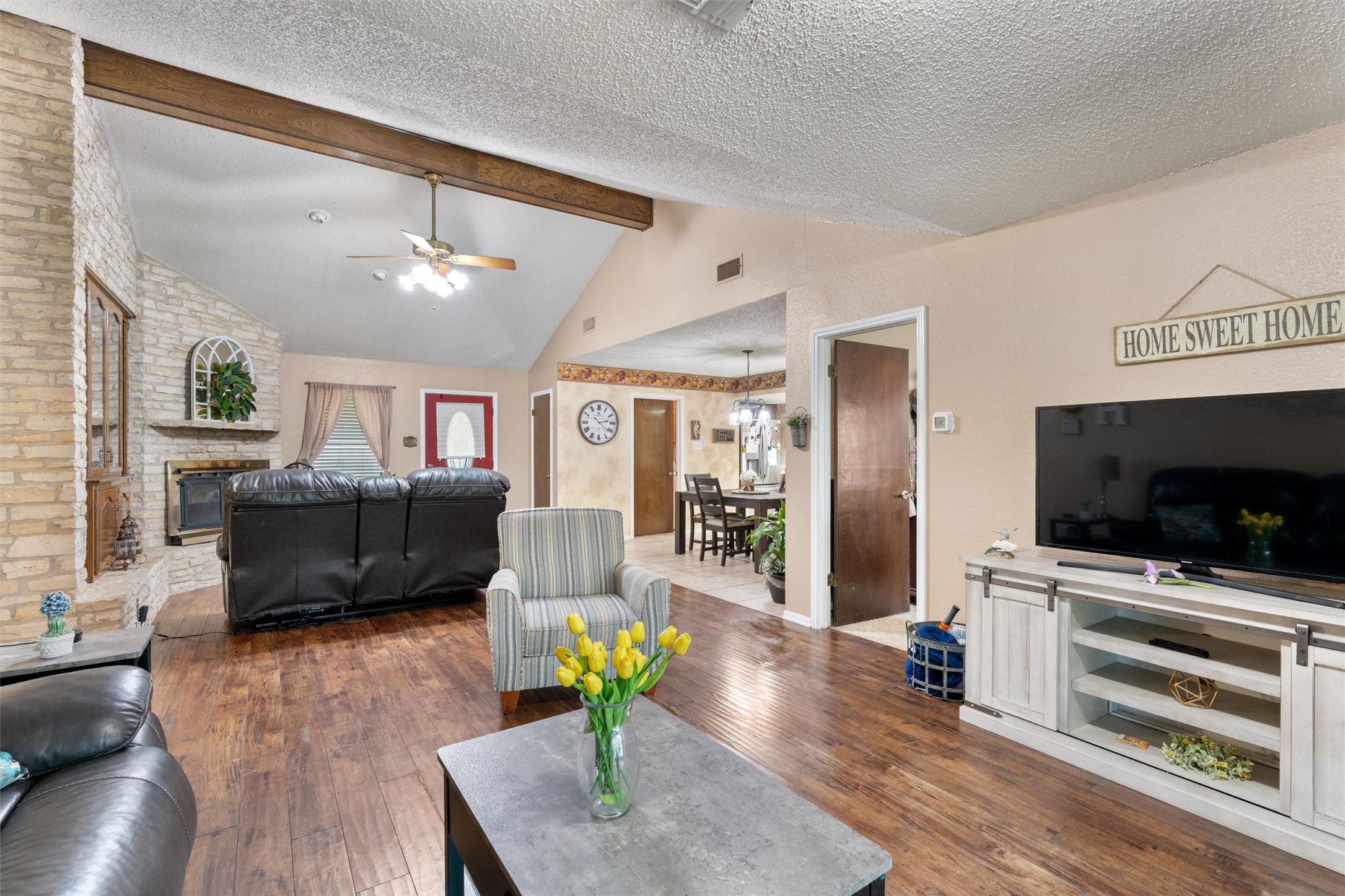 401 Drake Lane Taylor, TX 76574 - Photo 7 of 31 Living area featuring wood-finish flooring and a vaulted ceiling with exposed wood beams