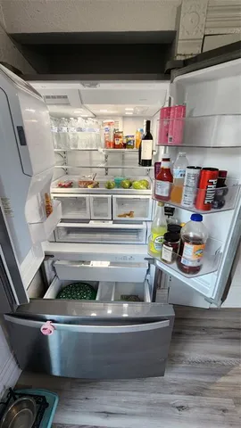 a kitchen with stainless steel appliances a stove a microwave and wooden floors