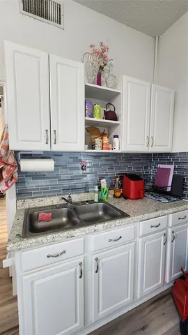 a bedroom with a bed and a wooden floor