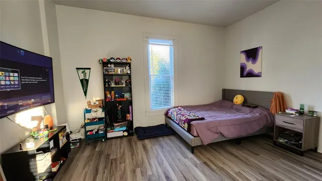 a bedroom with a bed and a window