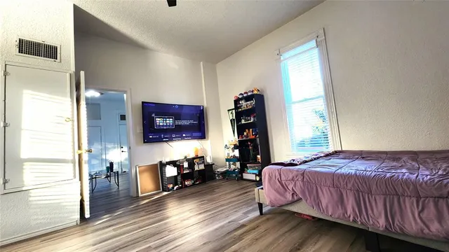 a view of a livingroom with furniture and a flat screen tv