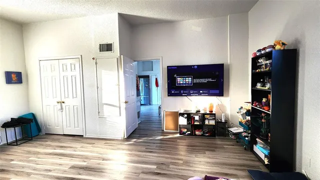 a view of a hallway view with wooden floor and furniture