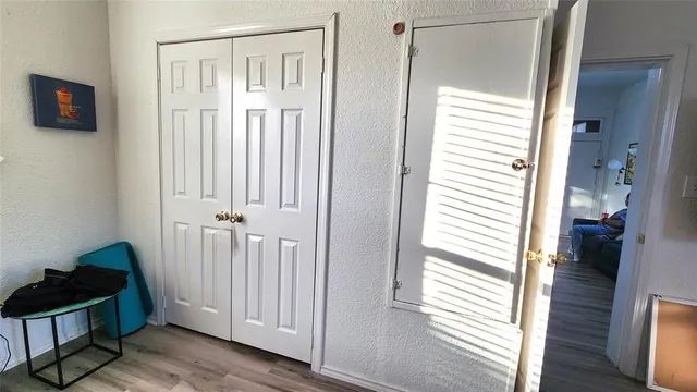 a view of a workspace with furniture and wooden floor