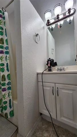 a white toilet sitting next to a shower curtain