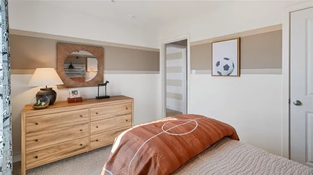 a bedroom with a bed and a dresser