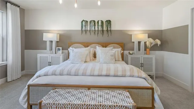 a bedroom with a large bed and a lamp on table