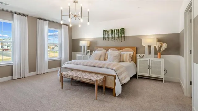 a spacious bedroom with a bed and a chandelier