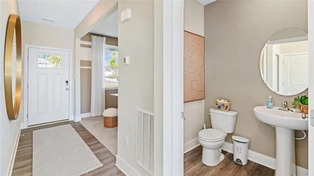 a bathroom with a toilet sink and a mirror