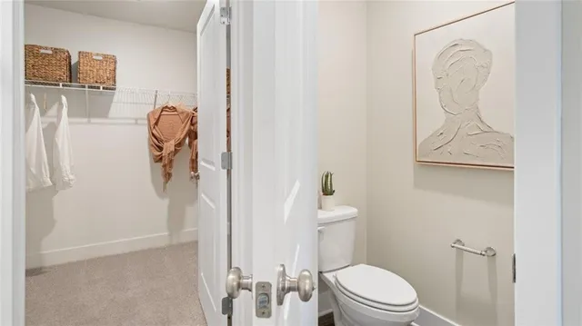 a white toilet sitting next to a bathroom sink