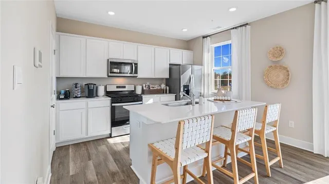 a kitchen with a sink cabinets and refrigerator