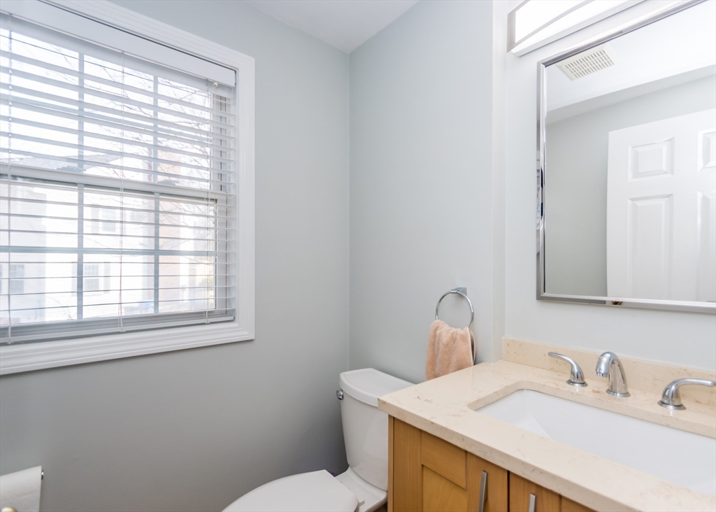 985 Trapelo Road, Unit 23 Waltham, MA 02452 - Photo 4 of 27 a bathroom with a sink a toilet and a window