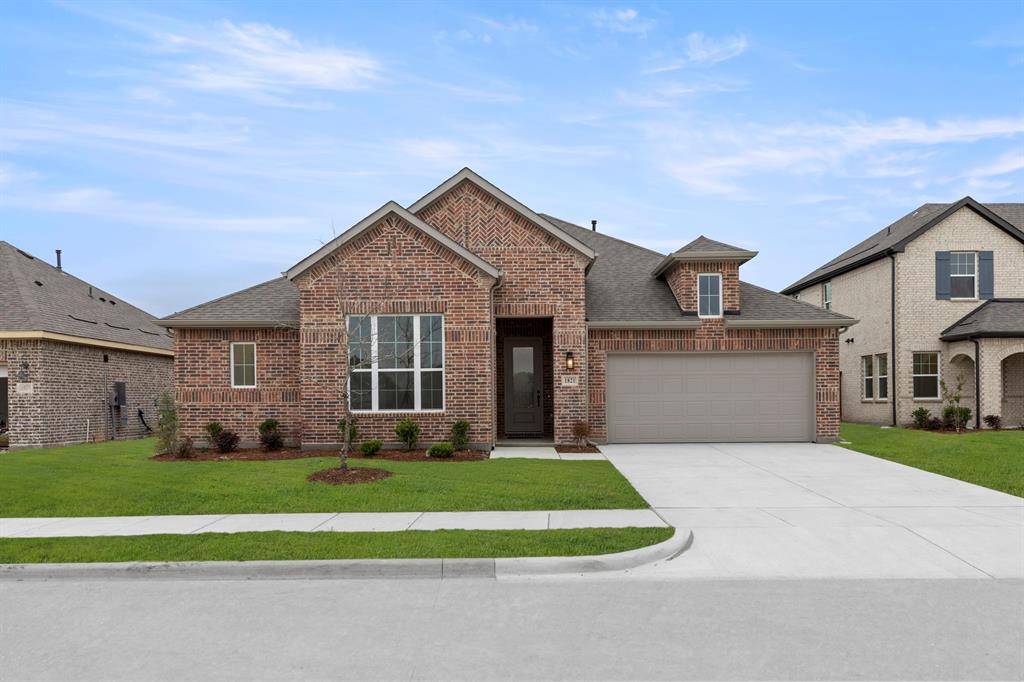 1821 Bachman Lane Forney, TX 75126 - Photo 1 of 27 a front view of a house with a yard and garage