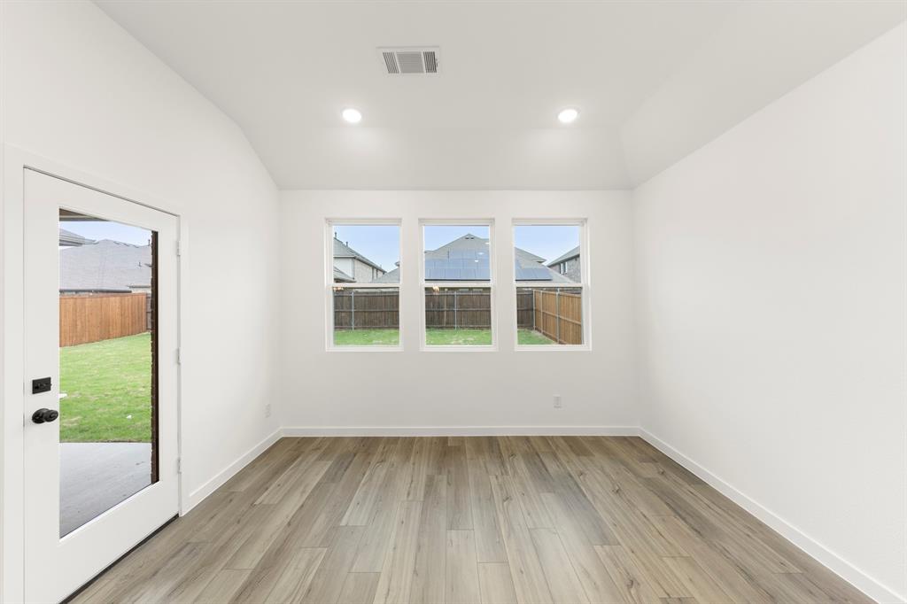 1821 Bachman Lane Forney, TX 75126 - Photo 15 of 27 an empty room with wooden floor and windows