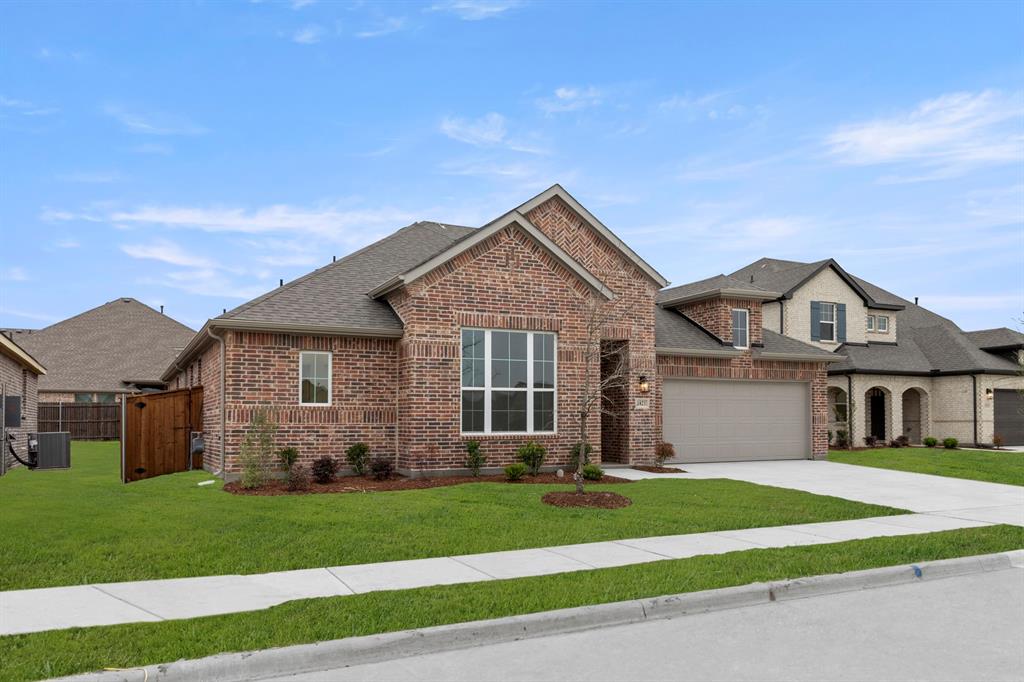 1821 Bachman Lane Forney, TX 75126 - Photo 2 of 27 a front view of a house with a garden and plants