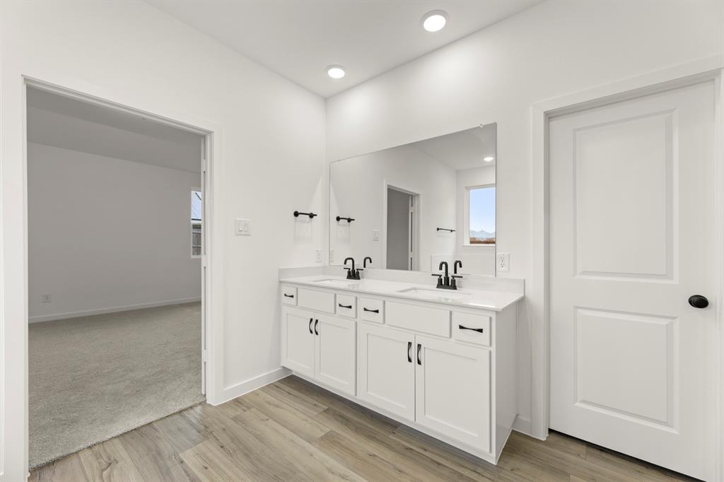 1821 Bachman Lane Forney, TX 75126 - Photo 21 of 27 a spacious bathroom with a double vanity sink and a mirror