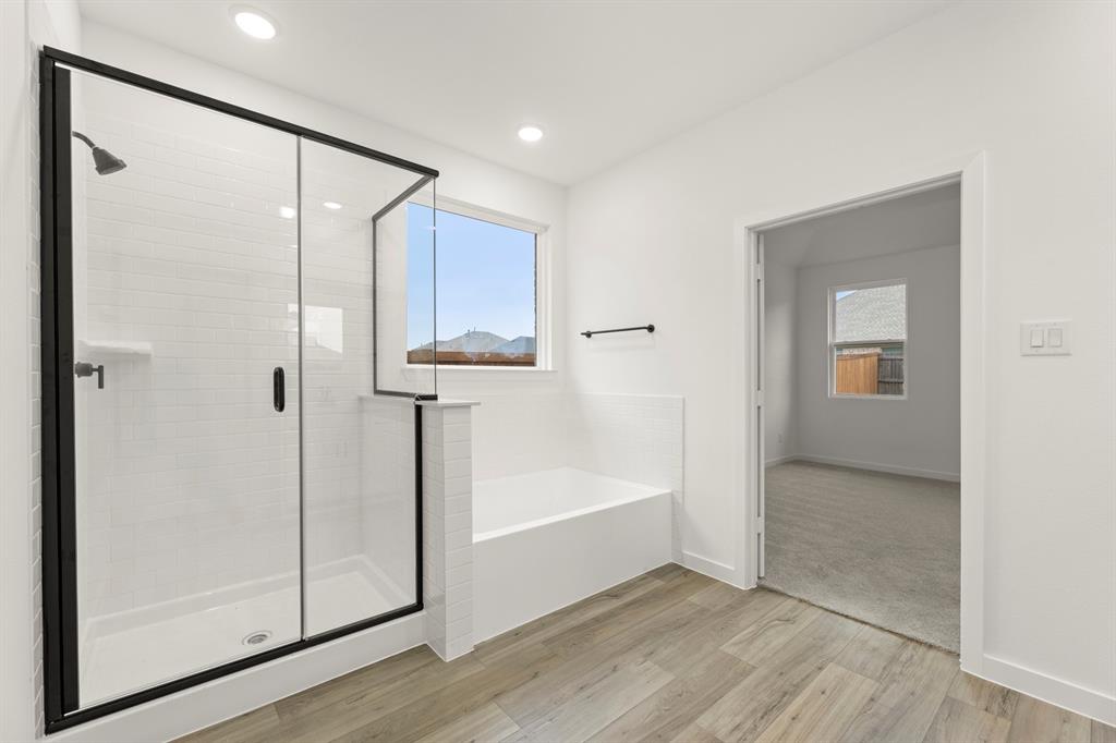 1821 Bachman Lane Forney, TX 75126 - Photo 22 of 27 a bathroom with a shower and a tub