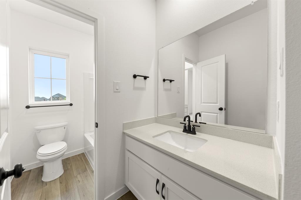 1821 Bachman Lane Forney, TX 75126 - Photo 5 of 27 a bathroom with a sink a toilet and shower
