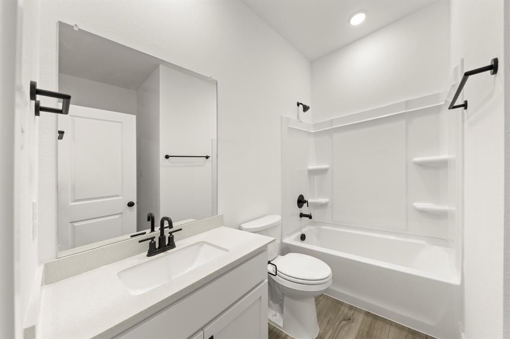 1821 Bachman Lane Forney, TX 75126 - Photo 7 of 27 a bathroom with a sink a toilet and shower