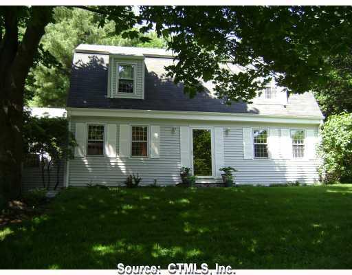 a front view of house with a garden