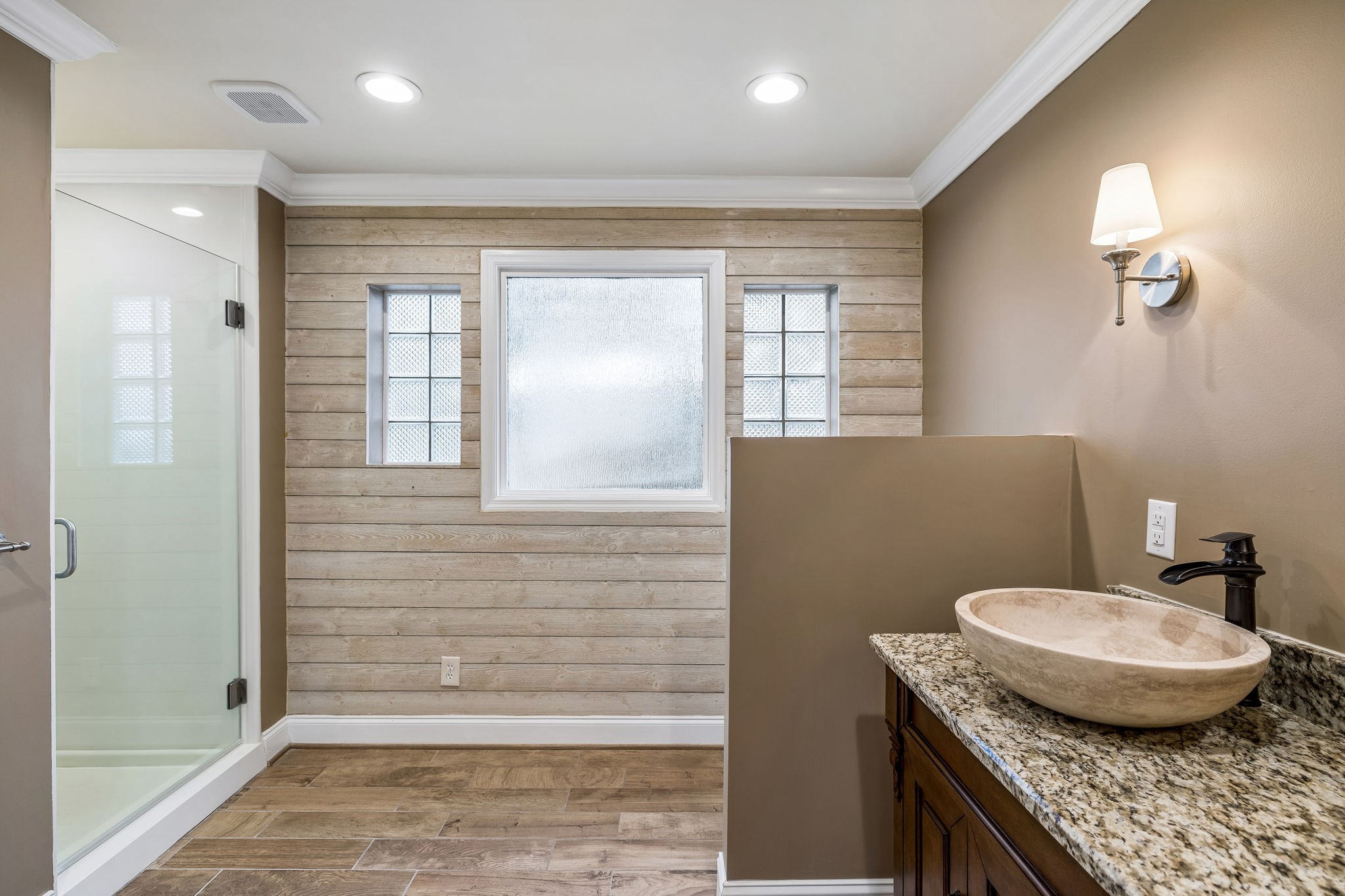 7301 Brush Creek Road Fairview, TN 37062 - Photo 12 of 30 a bathroom with a granite countertop sink a toilet a mirror and shower