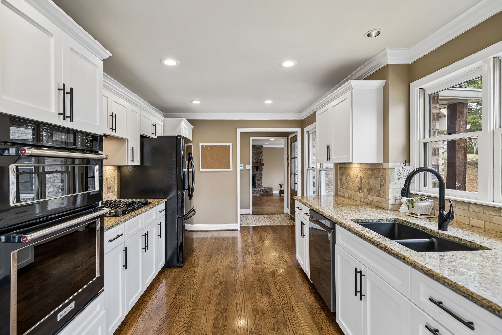 7301 Brush Creek Road Fairview, TN 37062 - Photo 5 of 30 a kitchen with stainless steel appliances a stove sink microwave and cabinets
