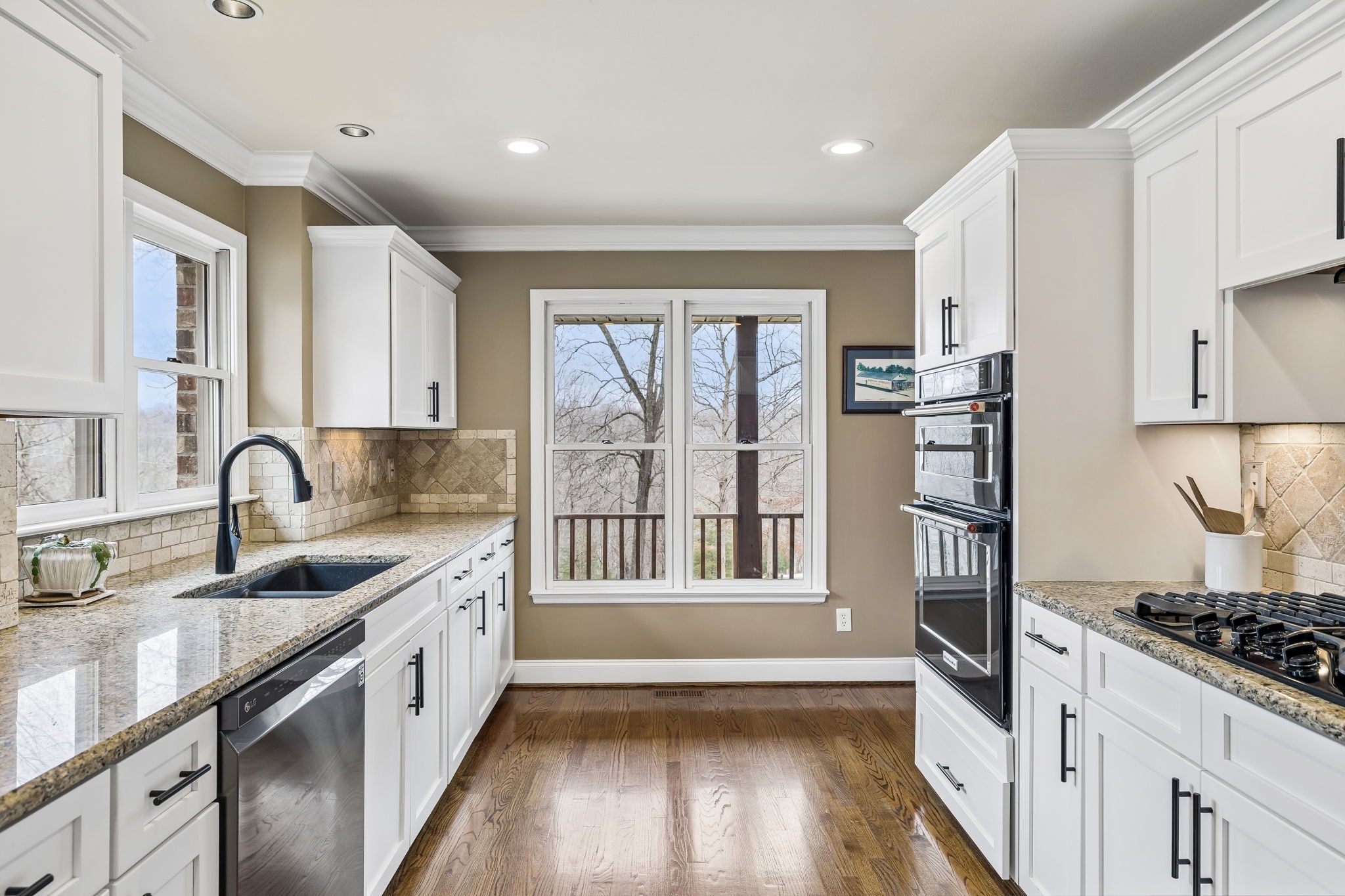 7301 Brush Creek Road Fairview, TN 37062 - Photo 6 of 30 a kitchen with granite countertop a sink stainless steel appliances and window
