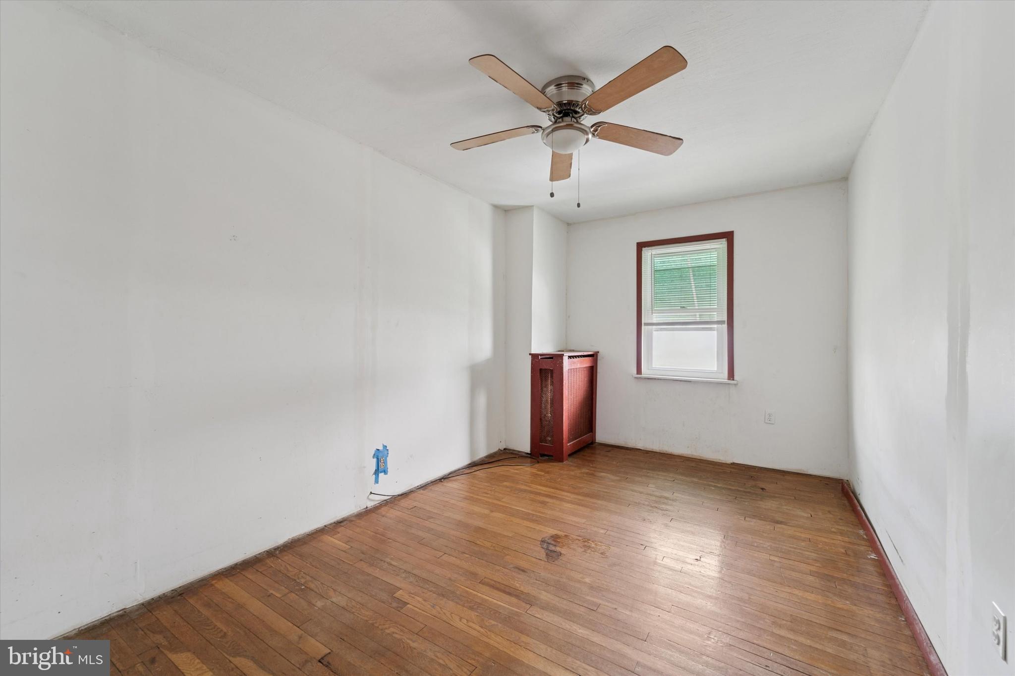 7250 Radbourne Road Upper Darby, PA 19082 - Photo 12 of 15 wooden floor in an empty room with a window