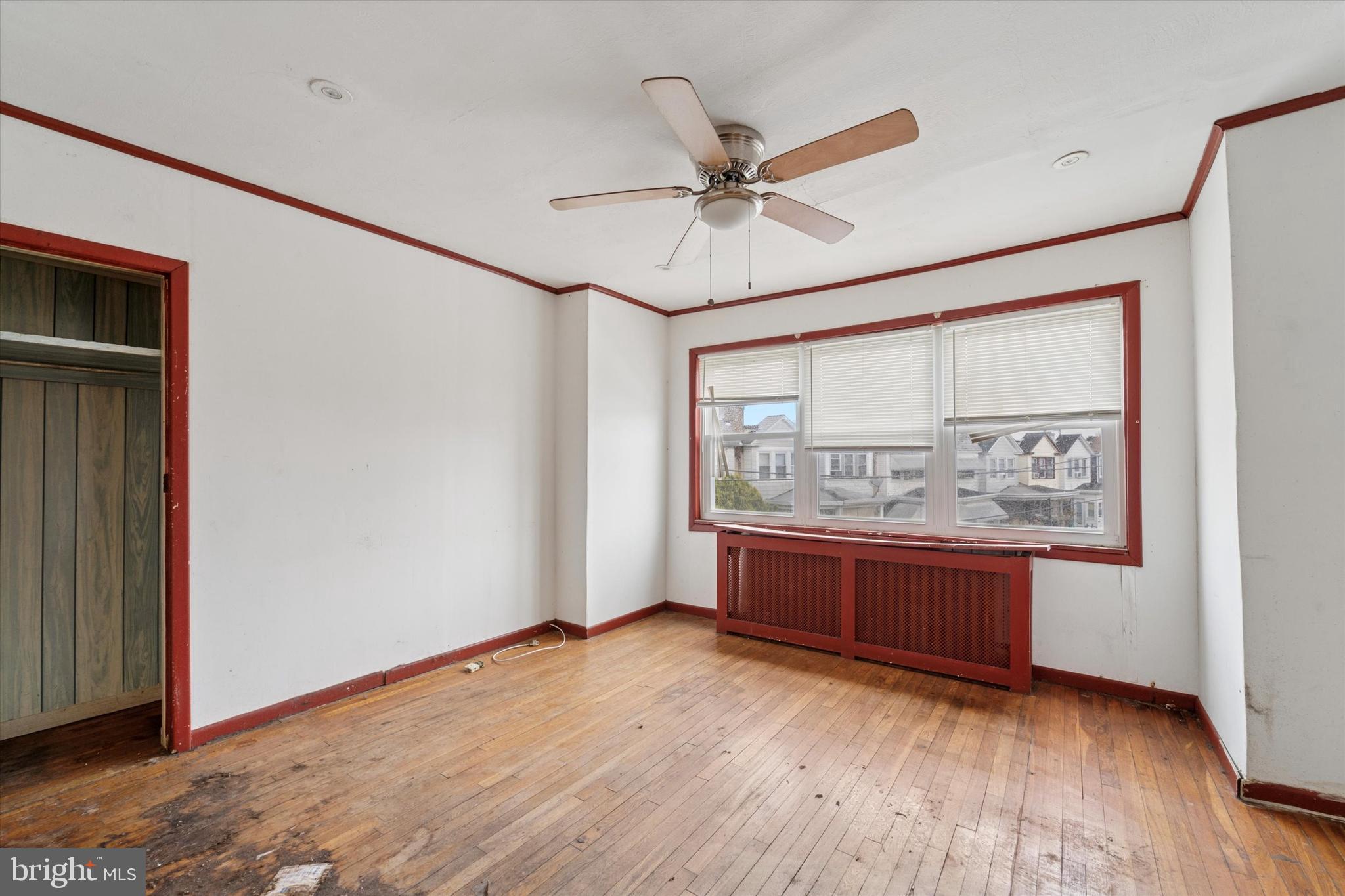 7250 Radbourne Road Upper Darby, PA 19082 - Photo 13 of 15 a view of an empty room with a window and wooden floor