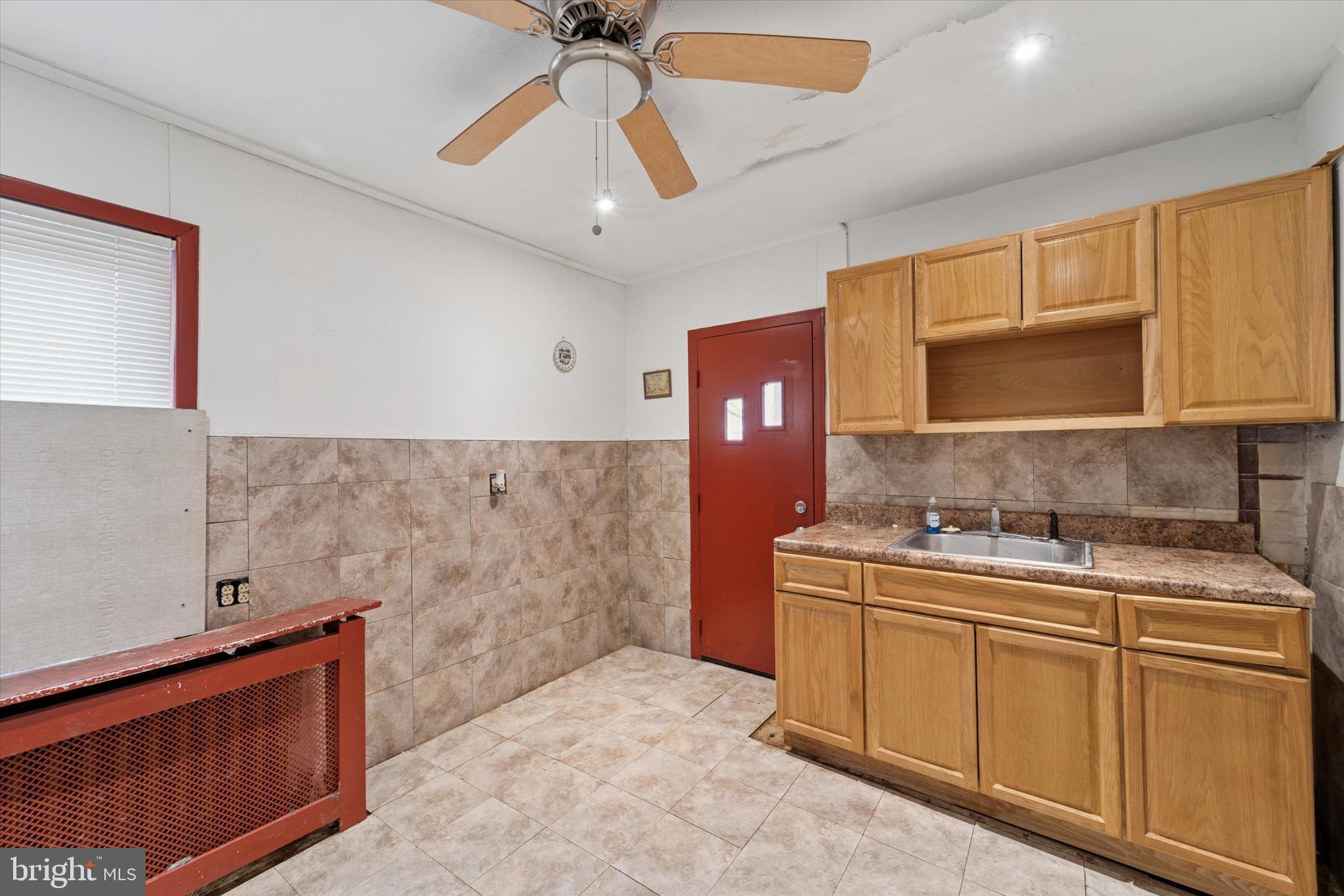 7250 Radbourne Road Upper Darby, PA 19082 - Photo 8 of 15 a kitchen with stainless steel appliances a sink stove and cabinets