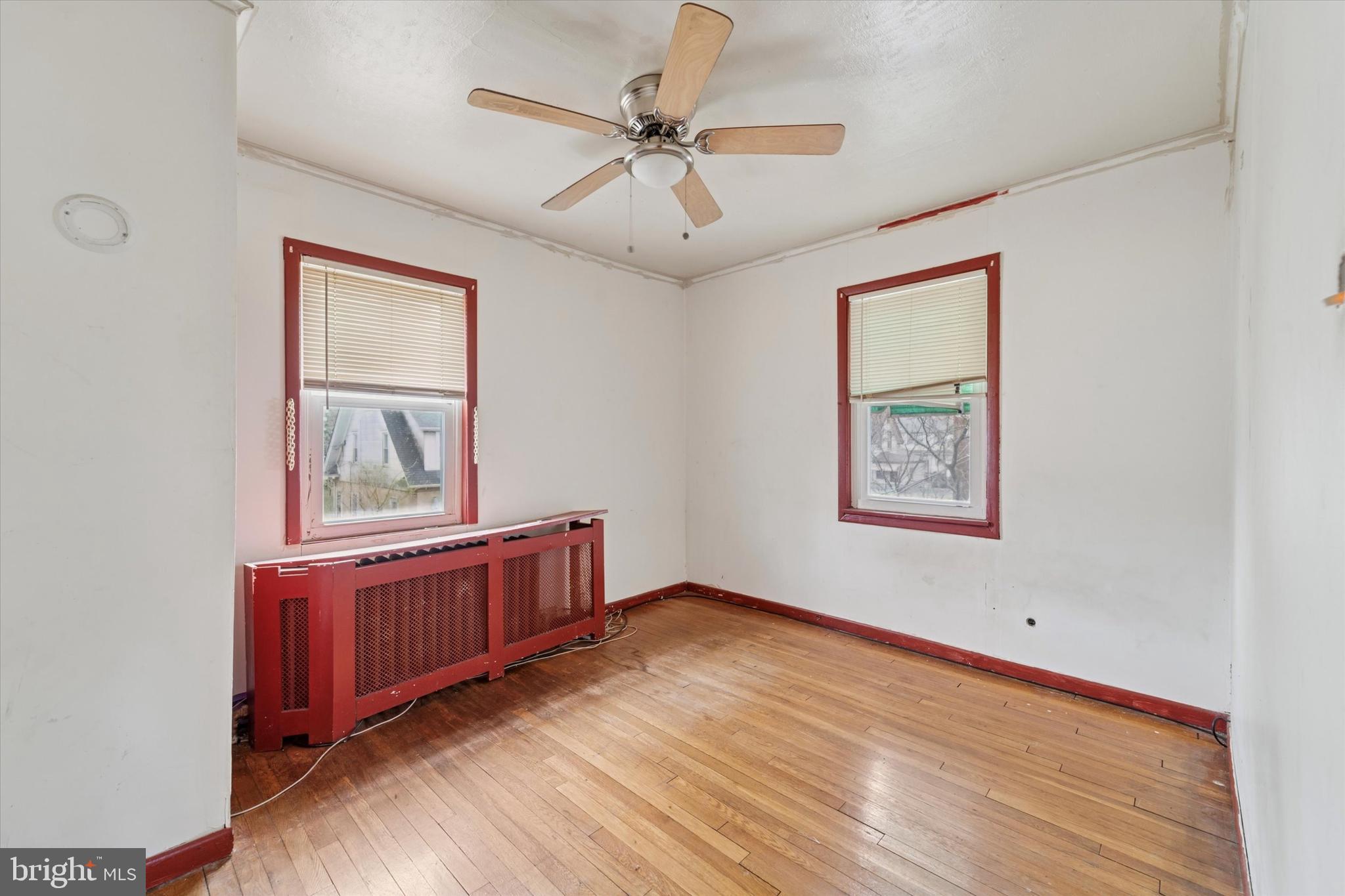 7250 Radbourne Road Upper Darby, PA 19082 - Photo 10 of 15 an empty room with windows and ceiling fan