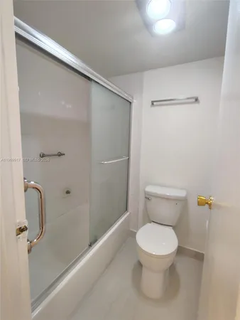 a white toilet sitting next to a bathroom sink